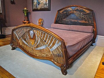 Dawn and Dusk Bed (1901). Dawn is illustrated by marquetry mayfly at the foot of the bed, dusk on the mayfly on the headboard (Musée de l'Ecole de Nancy)