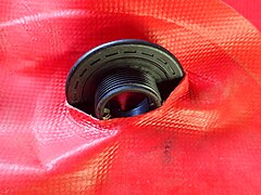 Internal fitting passing through the hole in a buoyancy compensator bladder