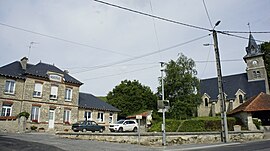 The town hall and church in Méry-Prémecy