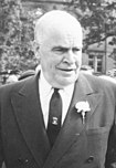 A black-and-white image of a white man in a suit
