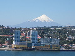 View of Puerto Montt's sea-side downtown in foreground and Osorno volcano in the background.