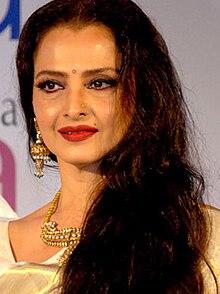 Rekha is looking at the camera.