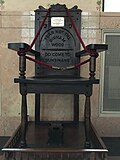 The "MacBeth Chair" on display in the Special Collections Department of Cleveland Public Library. The plate affixed to the chair identifies it as being crafted from "Burnam Wood" oak, and it is inscribed with "Fear not till Birnam Wood do come to Dunsinane." (Act V, Scene 5, line 2405–6)