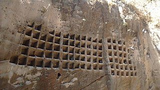 Soft rock hewn to make niches for birds