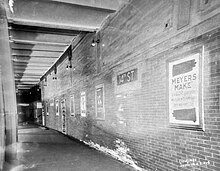Black-and-white image of the now-closed side platform on the 14th Street station of the IRT Lexington Avenue Line. To the left is the platform, while to the right is a brick wall.