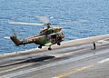 A French Army Light Aviation SA 330 Puma lands on the US aircraft carrier USS George Washington
