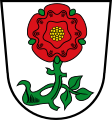 Gemeinde Tüßling In Silber eine rote heraldische Rose an beblättertem grünen Zweig.
