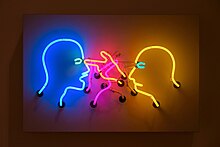 a neon and aluminium sculpture depicts two people, each poking the others' eye