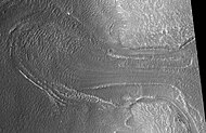 Probable glacier as seen by HiRISE under HiWish program. Radar studies have found that it is made up of almost totally of pure ice. It appears to be moving from the high ground (a mesa) on the right. Location is Ismenius Lacus quadrangle.