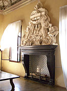 carved marble fireplace mantel over a fireplace