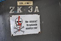 Skull and crossbones sign mounted on a power box in Poland