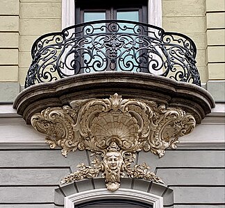 Rococo Revival mascaron surrounded by shells and round shapes (aka volutes), on the facade of Strada General H. M. Berthelot no. 41, Bucharest, unknown architect, 1911[42]