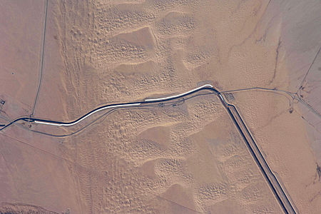This image captures about 15 kilometers (9.3 mi) of the All-American Canal just west of Yuma, Arizona; photo is taken of the southern section of the Algodones Dunes