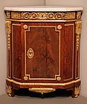 Louis XVI corner cabinet; by Jean Henri Riesener; 1780–1790; oak, mahogany, marble, and gilt-bronze mounts; 94.3 × 81.3 × 55.9 cm; Art Institute of Chicago (US)[5]