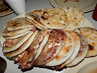 The pupusa is a Mesoamerican dish of Pipil origin. The oldest direct evidence of pupusa preparations in the world comes from a 1,400-year-old Maya site, Joya de Cerén, in El Salvador.