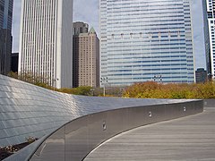 A modern parapet with integrated lighting functions as a guard rail along the BP Pedestrian Bridge in Chicago