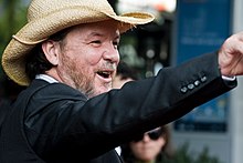 Photograph of a bearded, middle-aged man in a cowboy hat