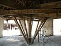 Horse shaft fixed to one of four long beams, all braced to each other with stretchers, and each fixed to the side of the top of the main axle.