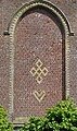 Rune-shaped designs (five-lozenges cross and heart) on the gable of Ledringhem's church