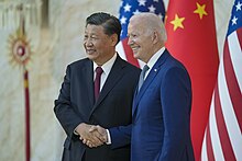 Joe Biden and Xi Jinping smiling and shaking hands