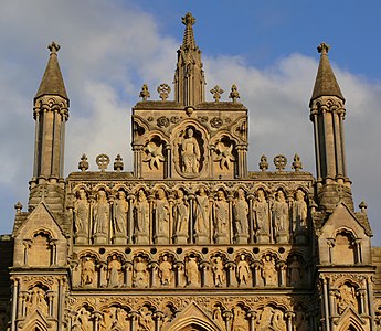 The gable of Wells Cathedral, with Christ the Judge (modern replacement) above the twelve apostles and the nine archangels. (14th century)