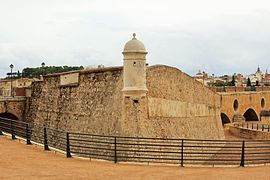 Acute-angled west flank curtain walls, moat and bartizan