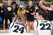 Clark on the sidelines with her Iowa teammates