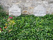 Two graves and two gravestones side by side; heading behind a bed of green leaves, bearing the remains of Vincent and Theo van Gogh, where they lie in the cemetery of Auvers-sur-Oise. The stone to the left bears the inscription: Ici Repose Vincent van Gogh (1853–1890) and the stone to the right reads: Ici Repose Theodore van Gogh (1857–1891)
