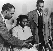Roy Wilkins in press conference with Autherine Lucy and Thurgood Marshall, director and special counsel for NAACP Legal Defense and Education Fund]. Autherine Lucy was the first African-American student to attend the University of Alabama who later expelled her.
