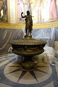 The baptismal font, with figure of John the Baptist