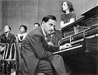 Blitzstein (with Stanton leaning on the piano, January 1938)