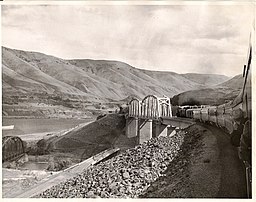 Depth of John Day Dam pool is illustrated by this 1967 photo showing the new UPRR bridge, with old bridges at sites to be submerged below.