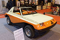 A front-quarter view of the A112 Giovani shows the beige, orange and black colour scheme.