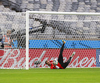 Neuer makes a save in front of an empty stadium in training