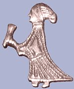 A silver figure of a woman holding a drinking horn found in Birka, Björkö, Uppland, Sweden.