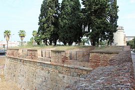 Curtain wall to the west with embrasures defending the moat and Palmas Gate in the background