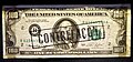 An overprinted Series 1974 counterfeit $100 bill, marked 'Contrefaçon' (counterfeit in French) to indicate its status as a fake