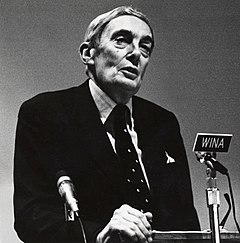 Lord Scarman at a lectern, giving a speech