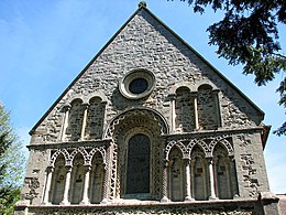 Overlapping arches form a blind arcade at St Lawrence's church Castle Rising, England. (1150) The semi-circular arches form pointed arches where they overlap, a motif which may have influenced Gothic.