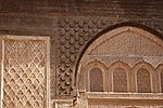 Carved stucco and wood decoration of the courtyard, with a variety of motifs including arabesques, calligraphy, pine cones, and darj w ktaf