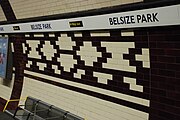 The complete design in the repeated platform frieze. As part of the station upgrade the platform tiling was replaced although the tone of the new tiles is darker than the originals.