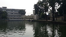 Large pond and college buildings