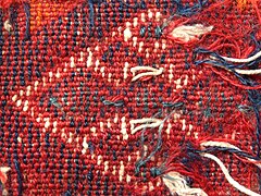 Detail of reverse showing ragged ends of weft threads of different colours