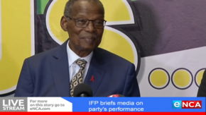 Buthelezi smiling, wearing a three-piece suit