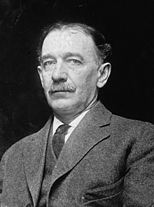 A black and white photograph of DeLancey Gill later in life, wearing a suit.
