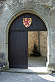 Main gate with a modern rendition of the Habsburg coat of arms with a red lion