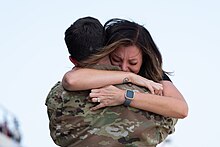 A U.S. Air Force Airman is welcomed home after deployment by a family member at Joint Base Charleston, South Carolina, October 2023.