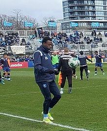 Bissainthe is kicking a football during warm-up