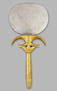 Ancient Egyptian mirror with a Hathor mascaron, c.1479–1425, disk: silver, handle: wood sheathed in gold with restored inlay, Metropolitan Museum of Art