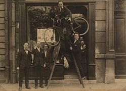Opening of the Max Ernst exhibition at the gallery Au Sans Pareil, May 2, 1921. Left to right: René Hilsum, Benjamin Péret, Serge Charchoune, Philippe Soupault (top of the ladder), Jacques Rigaut (upside down), André Breton and Simone Kahn-Breton